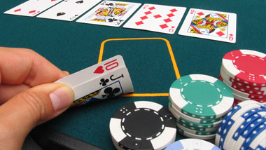 hand holding cards with chips