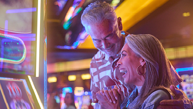 senior couple playing slots